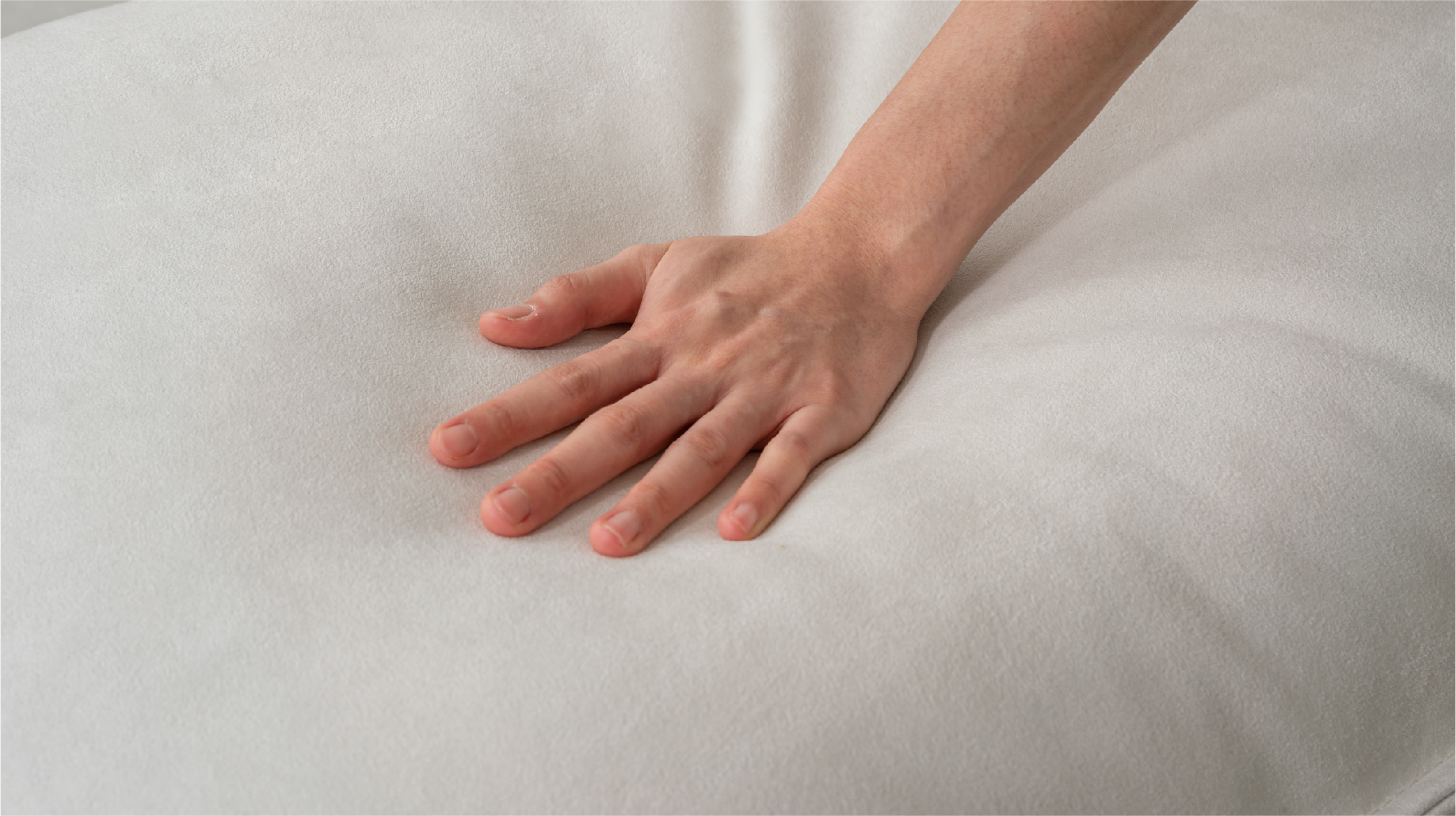 小躺躺沙發的Q彈坐感 一隻手正在觸摸、按壓沙發表面