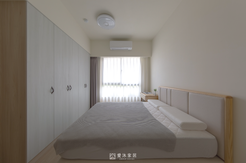 日式北歐風主臥設計，白色木紋系統衣櫃搭配淺木色家具，營造清爽溫潤的休息空間